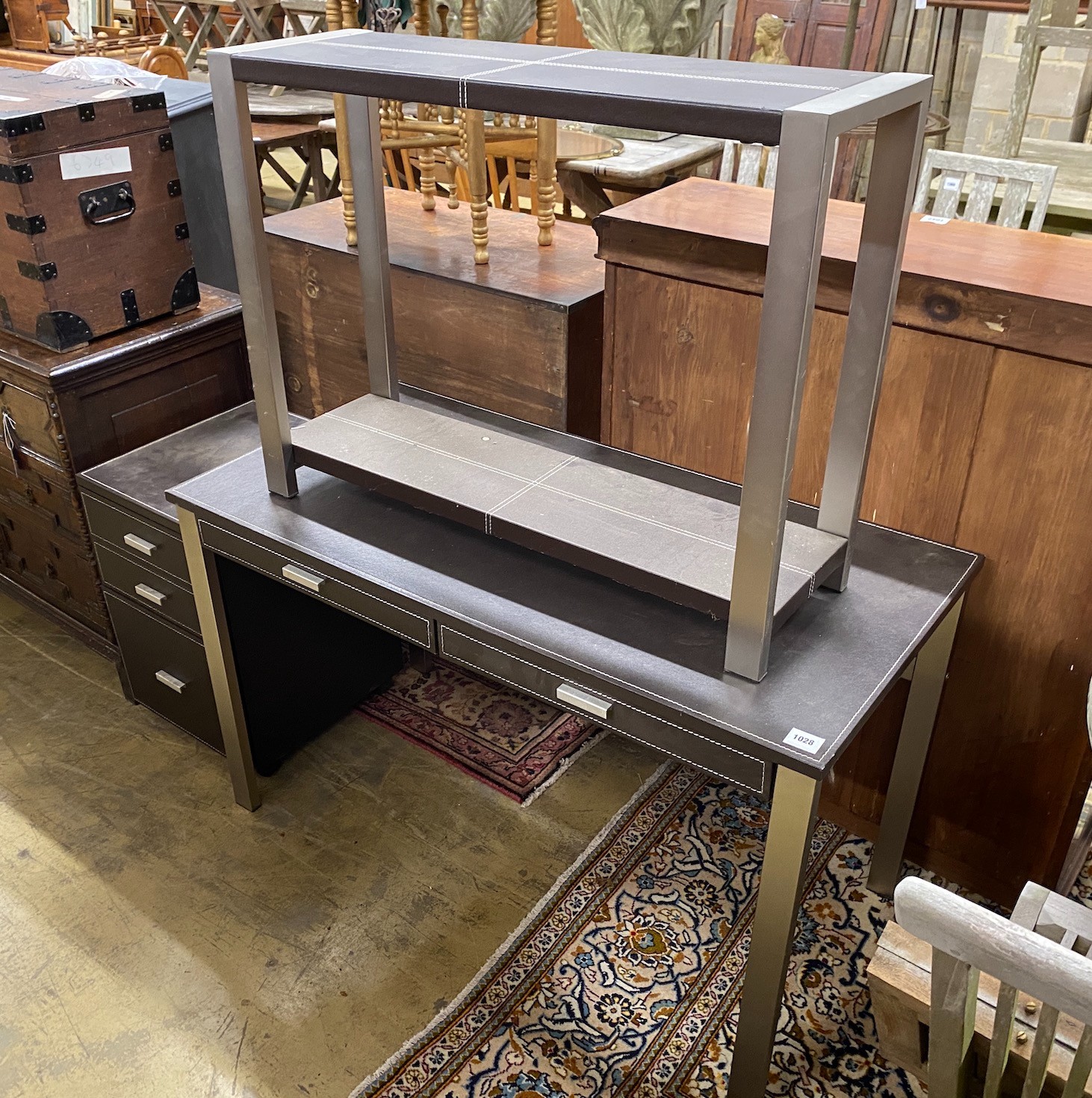 A leather topped and steel writing table, width 120cm, with matching three drawer chest, width 40cm and side table, width 92cm